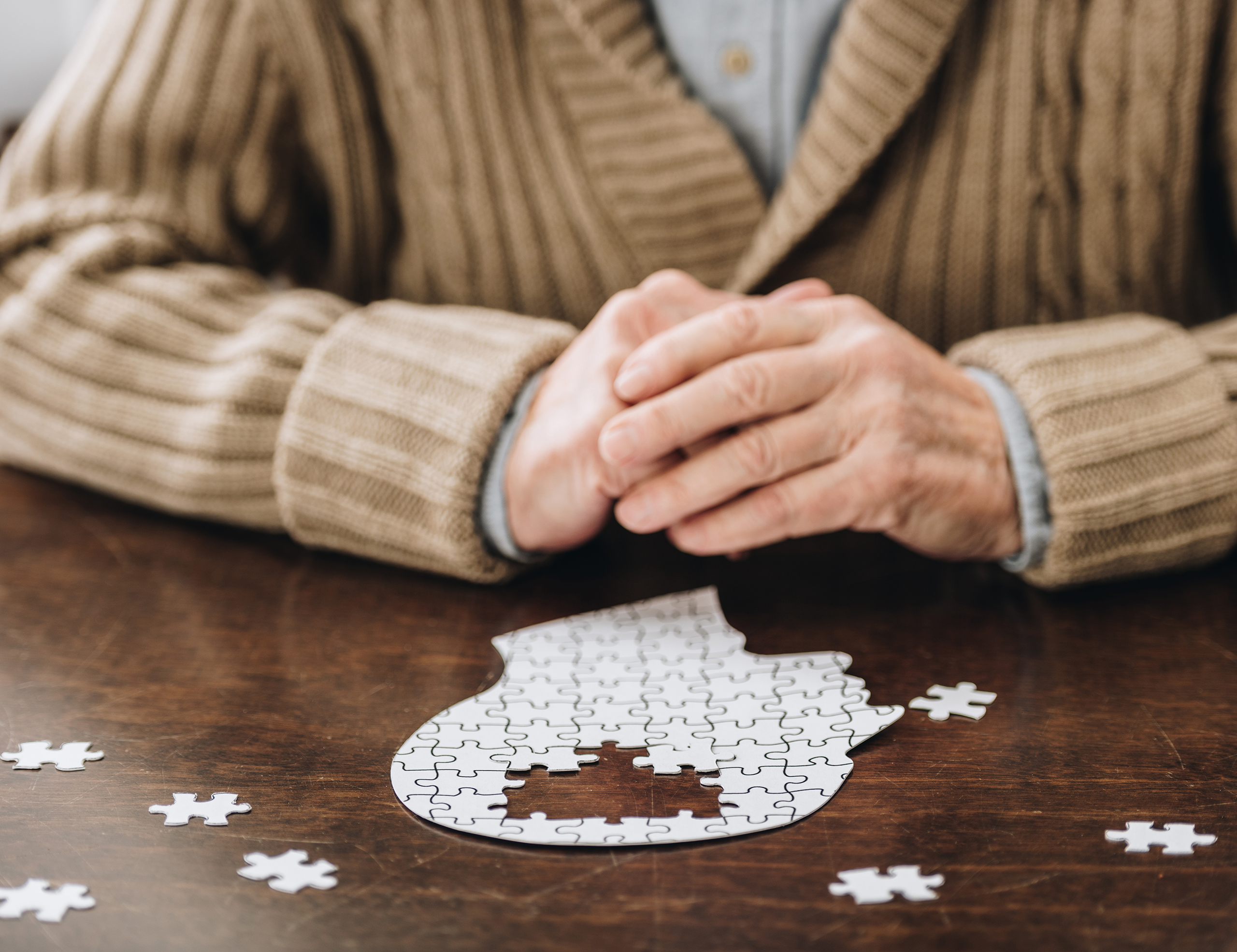 Cropped,View,Of,Senior,Man,Playing,With,Puzzles,On,Table